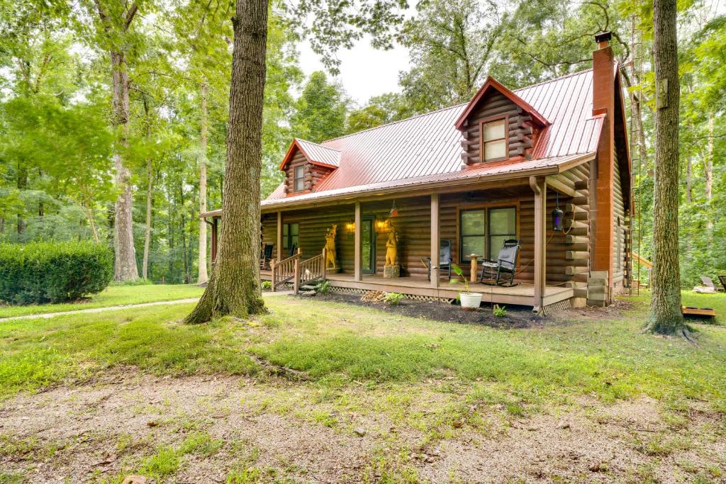 a log cabin in the woods with trees at Orleans Retreat with Private Hot Tub and Fireplace! 