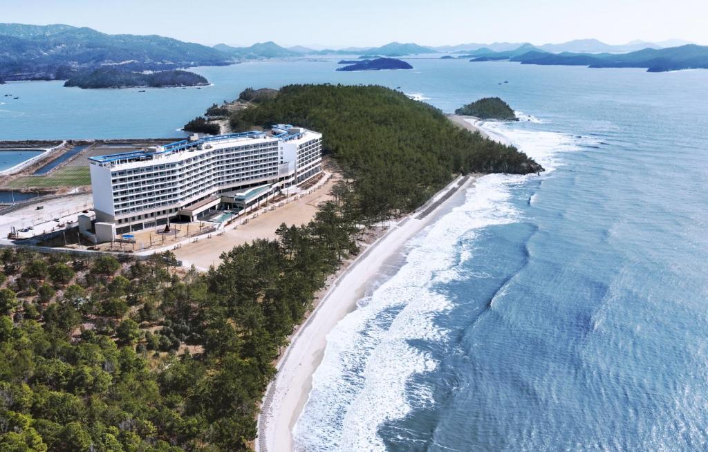 an aerial view of a hotel on the beach at Ramada Plaza by Wyndham Jaeun in Sinan