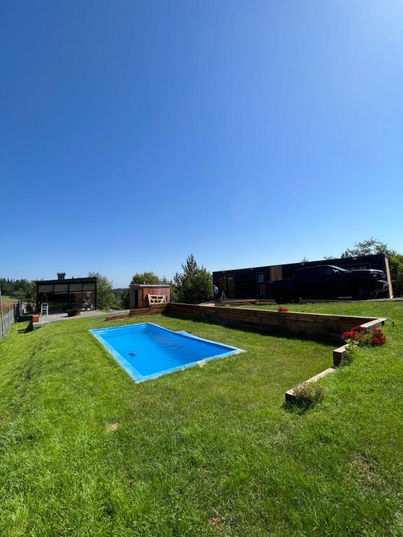 a yard with a swimming pool in the grass at Huinanco Lodge in Concepción