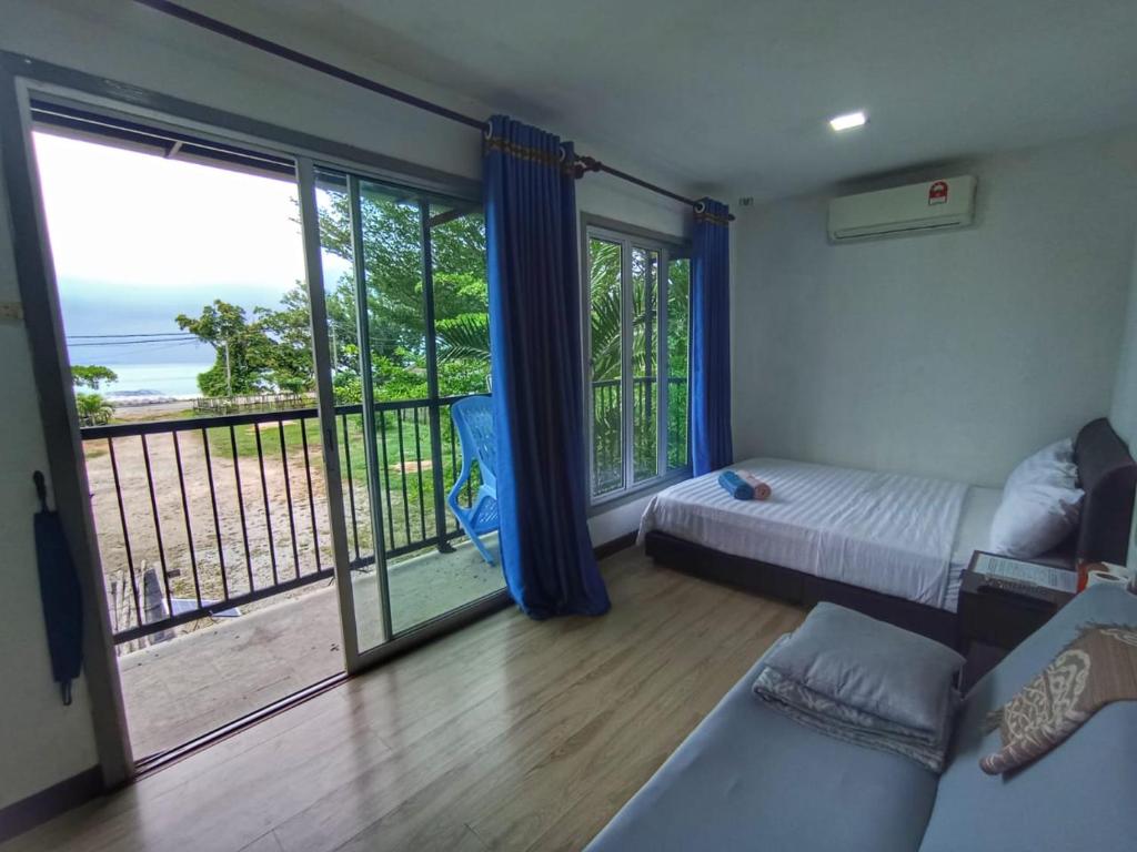 a bedroom with a bed and a view of the ocean at LeThuHouse in Melaka