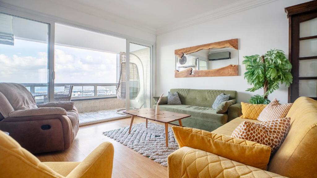a living room with a couch and a table at Gorgeous Seaview Condo in Gleem in Alexandria