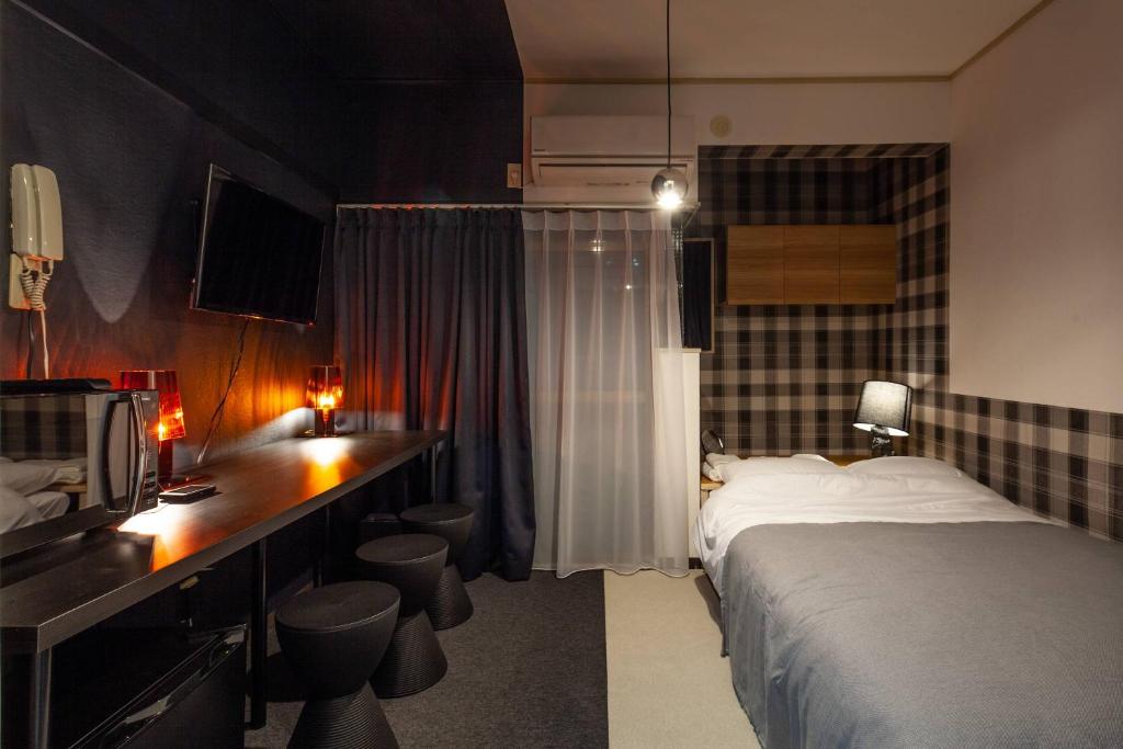 Кровать или кровати в номере SunPalace Nishi-Shinjuku