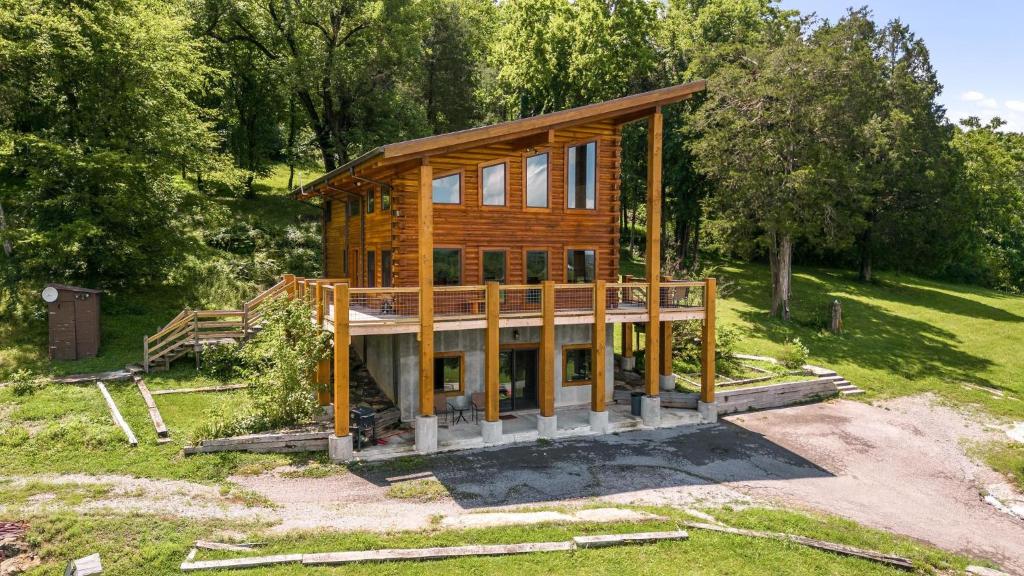 a house being constructed in a field with trees at Panoramic Paradise 3BR Cabin with Idyllic Views in Wartrace