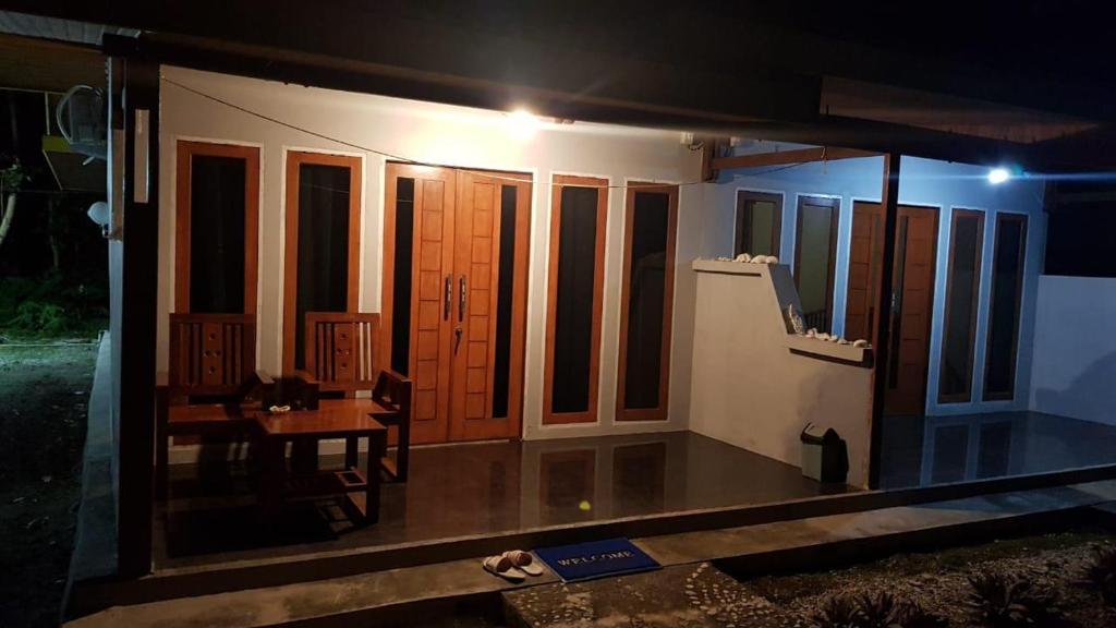 a room with a table and some windows at night at Amoryg Resort and Dive Raja Ampat in Pulau Mansuar