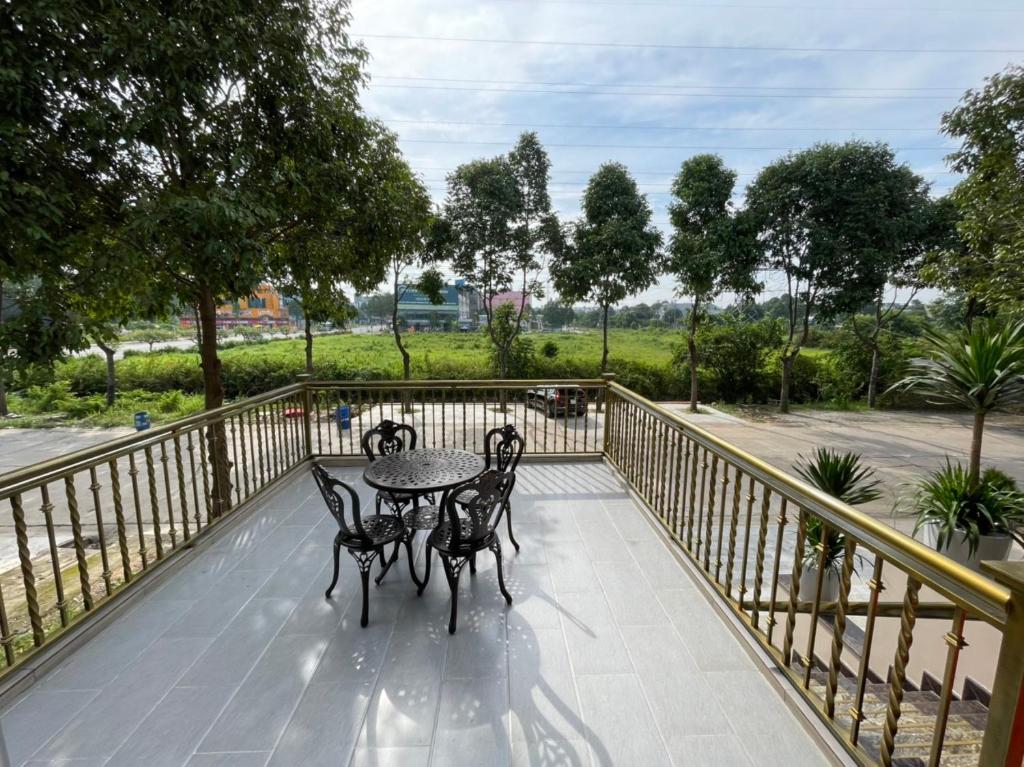 a patio with a table and chairs on a balcony at Anna Hotel Binh Duong in Bến Cát