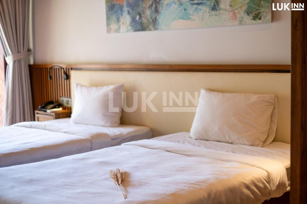 Postel nebo postele na pokoji v ubytování LUK Inn Hotel - An Thượng, Đà Nẵng