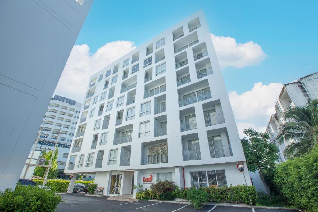 un edificio bianco in una città di Karin hotel & Service apartment - SHA Extra Plus a Si Racha