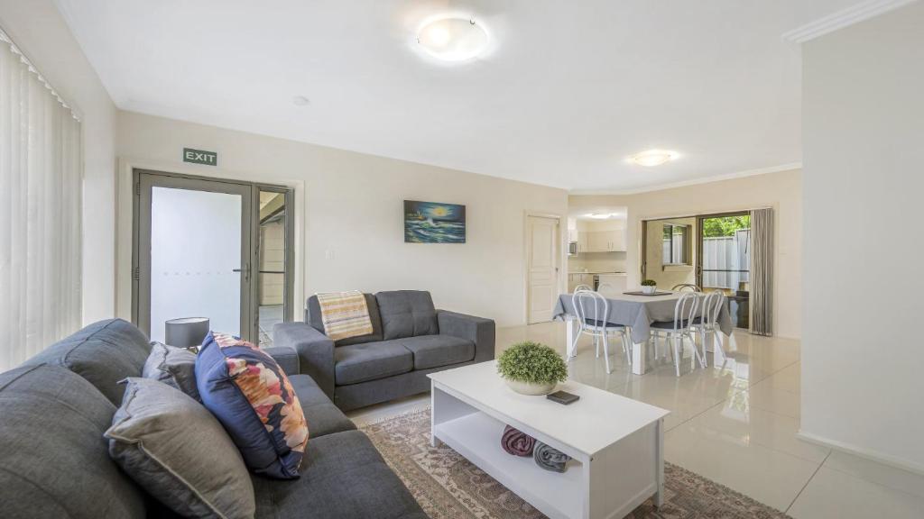 a living room with a couch and a table at Anne Street Monte - Vista in Port Macquarie