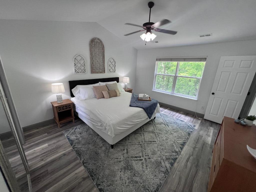 a bedroom with a bed and a ceiling fan at Springhurst Serenity Fresh 4BR Getaway in O'Fallon