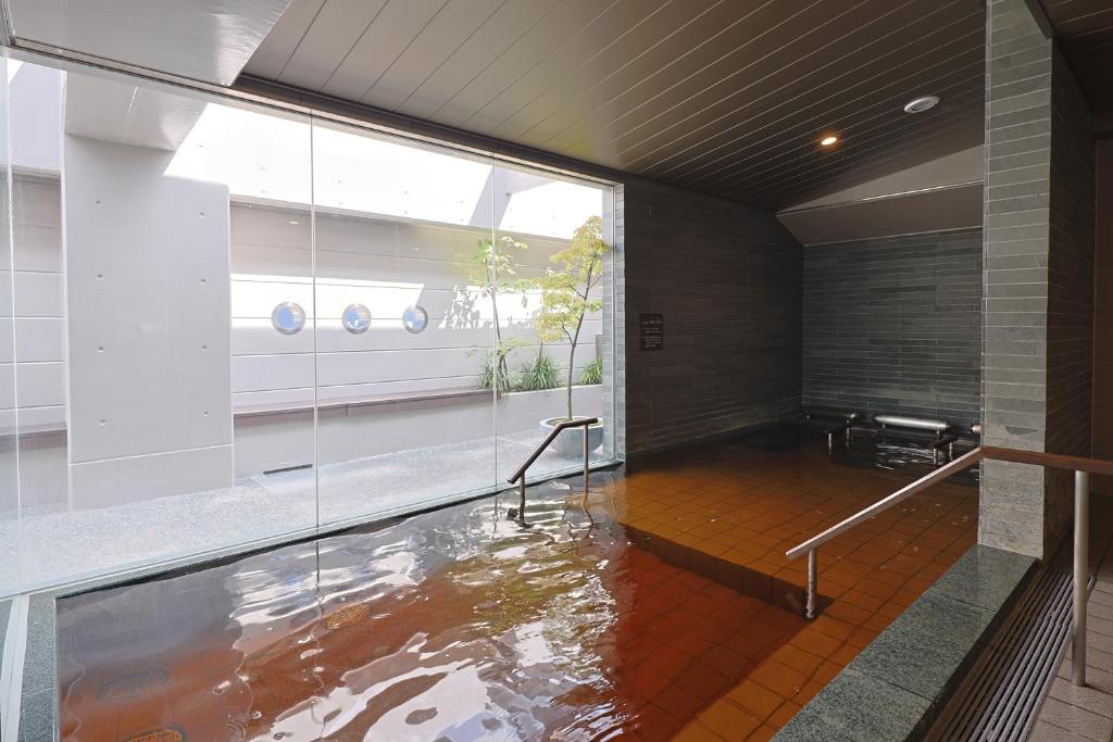 a room with a pool of water in the floor at Dormy Inn Kanazawa Natural Hot Spring in Kanazawa