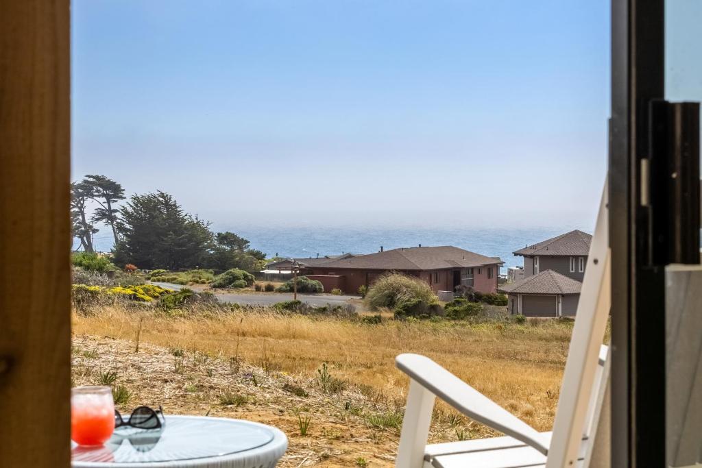 a table and a chair in a room with a window at Mar Vista in Bodega Bay