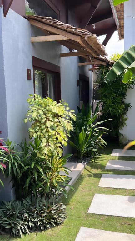 a garden outside a house with some plants at Yay Lodge SIARGAO, private room 1 with AC & hot shower and fast Starlink Wifi in General Luna