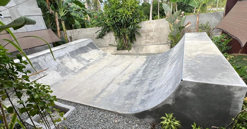 a skateboard ramp in a garden with a bench at Yay Lodge SIARGAO, private room 1 with AC & hot shower and fast Starlink Wifi in General Luna