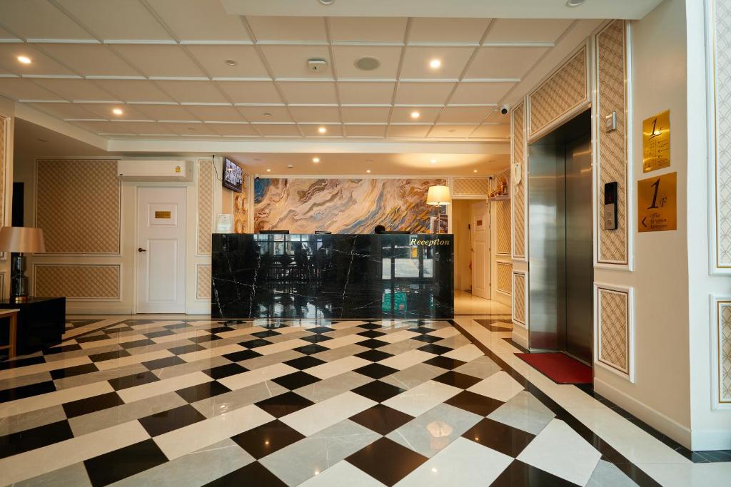 a lobby with a black and white checkered floor at Rose Apple Hotel in Bangkok
