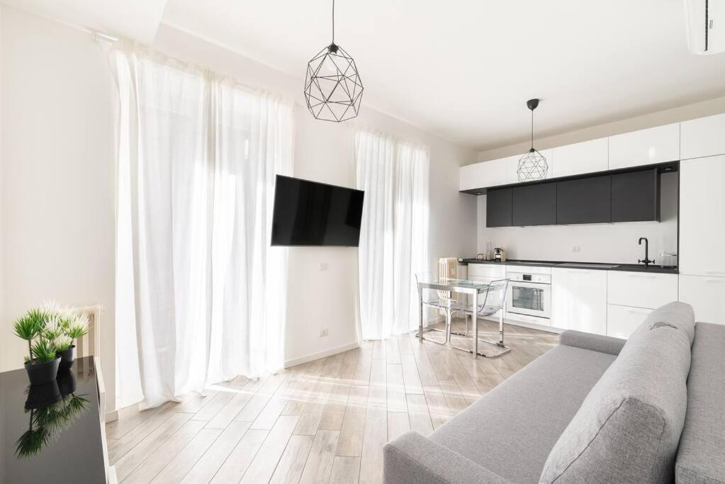 uma sala de estar com um sofá e uma cozinha em Appartamento: BuenosAires79 em Milão
