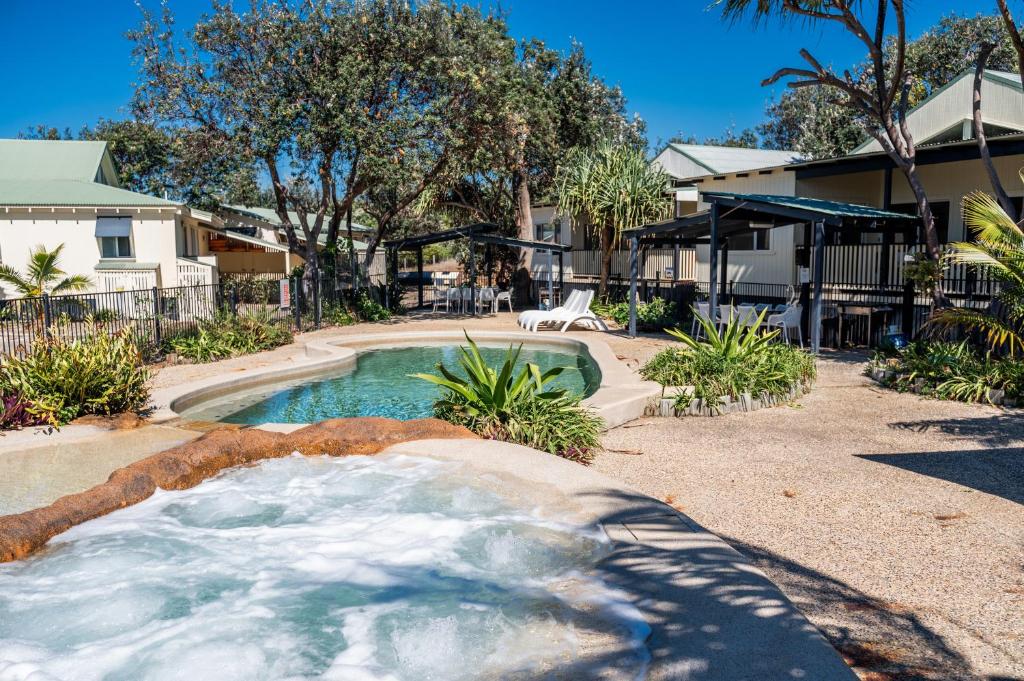 a swimming pool with a hot tub in a yard at E.V. - Eurong Beach Villa in K'gari Island (Fraser Island)