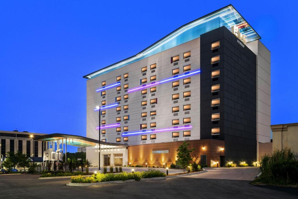 a large building with purple lights on it at Aloft Chicago Schaumburg in Rolling Meadows