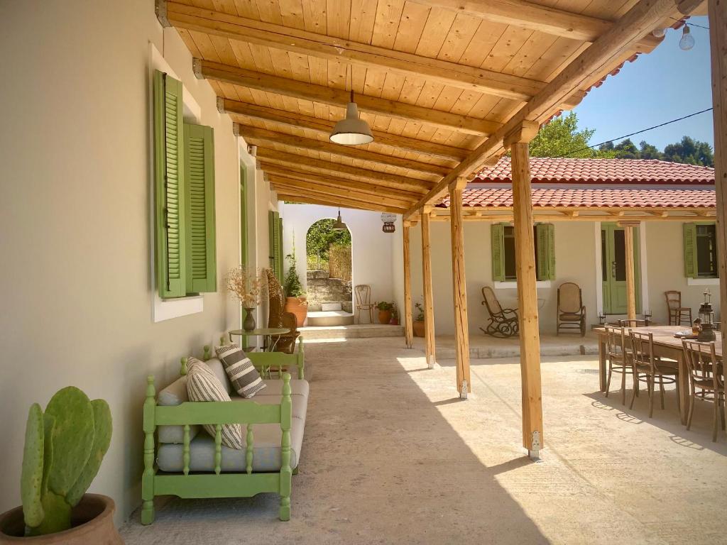 an outdoor patio with a wooden pergola at Lichada Villa's in Likhás