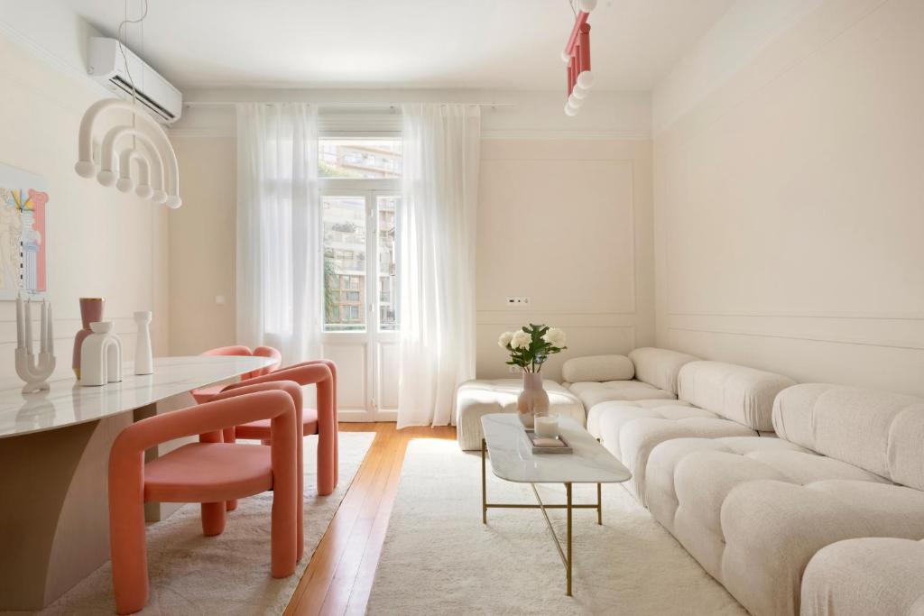 a living room with a white couch and a table at Loft in Acropolis in Athens