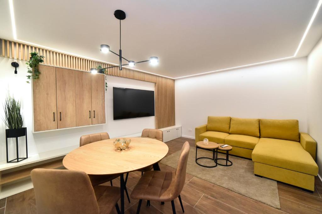 a living room with a table and a couch at Optima Apartment Zagreb - Spacious Central Stay in Zagreb
