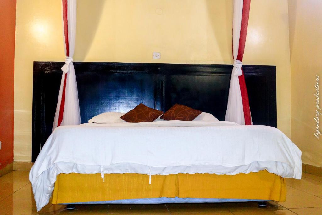 Postel nebo postele na pokoji v ubytování Jamia Central Hotel
