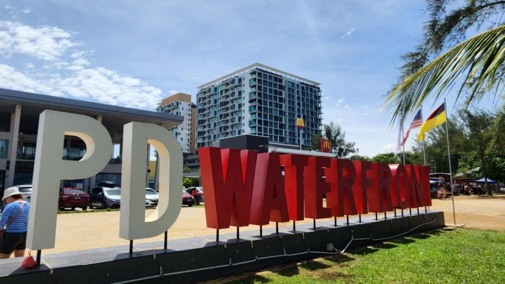 a large sign in front of a building at D'Wharf Hotel & Serviced Residence in Port Dickson