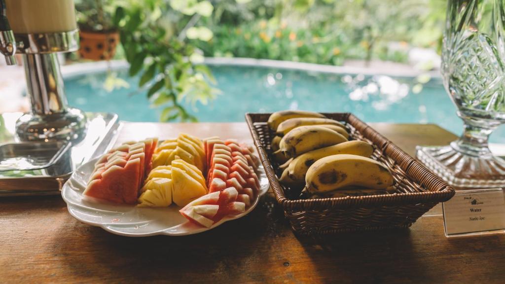 two baskets of fruit on a wooden table at Trang An Ecolodge in Ninh Binh