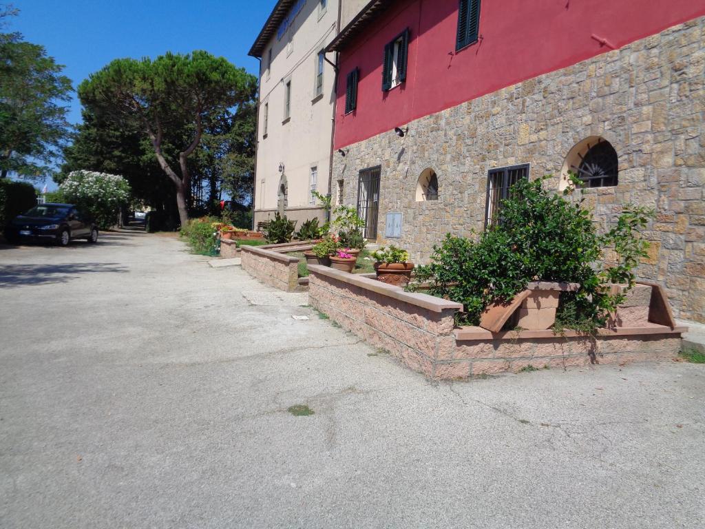 a brick building with potted plants in front of it at La Garitta Pisa - Villa sul fiume in Toscana zona mare in Pisa