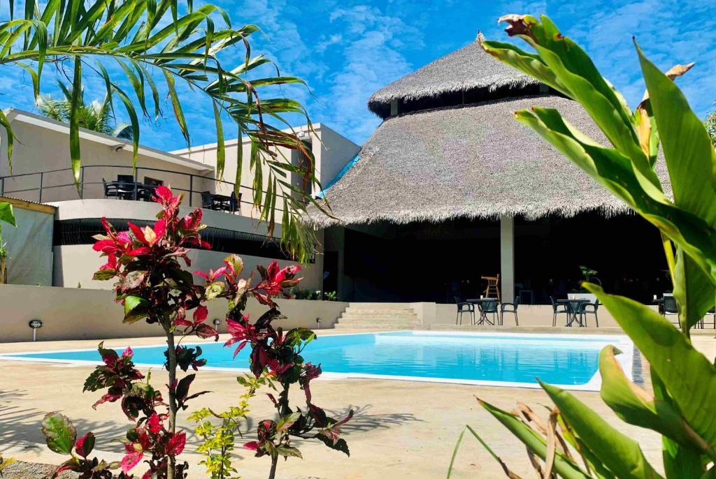 a view of a resort with a swimming pool at MAISON CARREE in Andilana