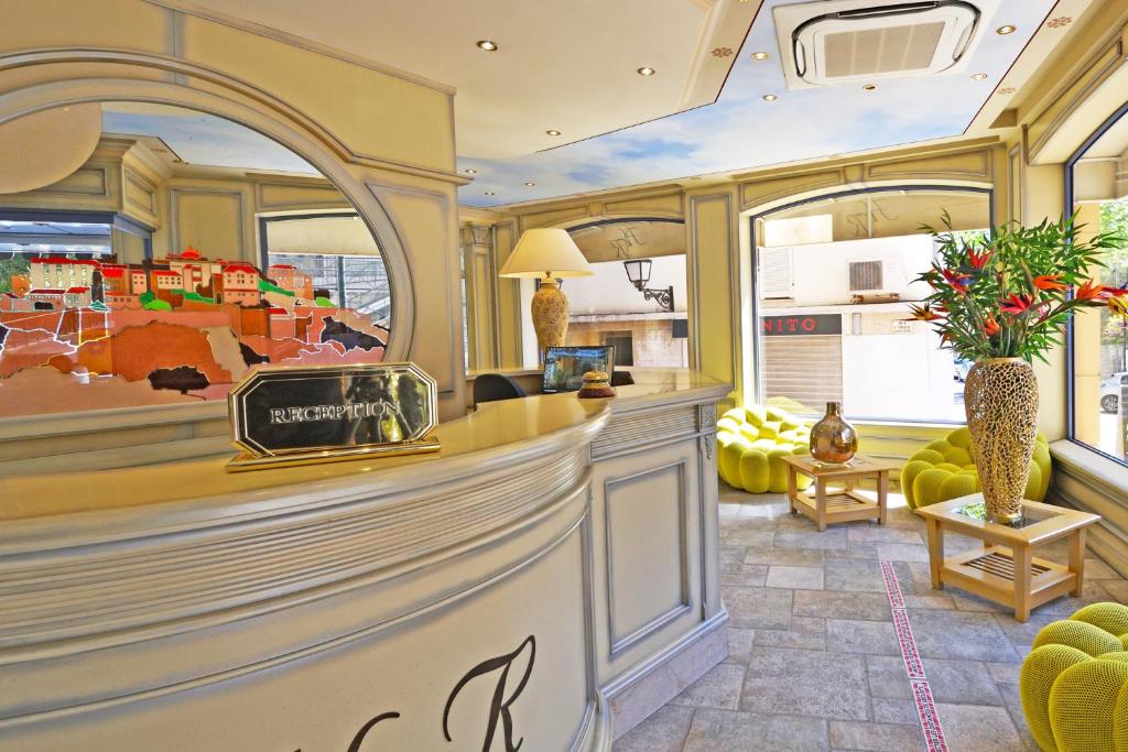 a hotel lobby with a counter and a waiting room at Hôtel Le Rocher in Calvi