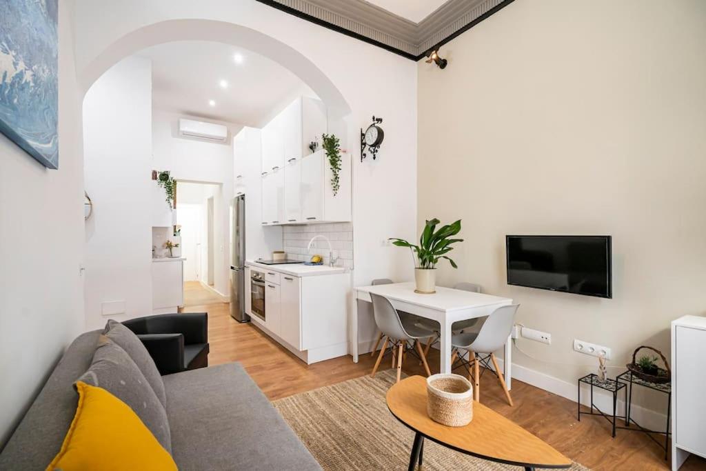 a living room with a couch and a table at Chamberi - Quiet flat, ideal for families CAS in Madrid