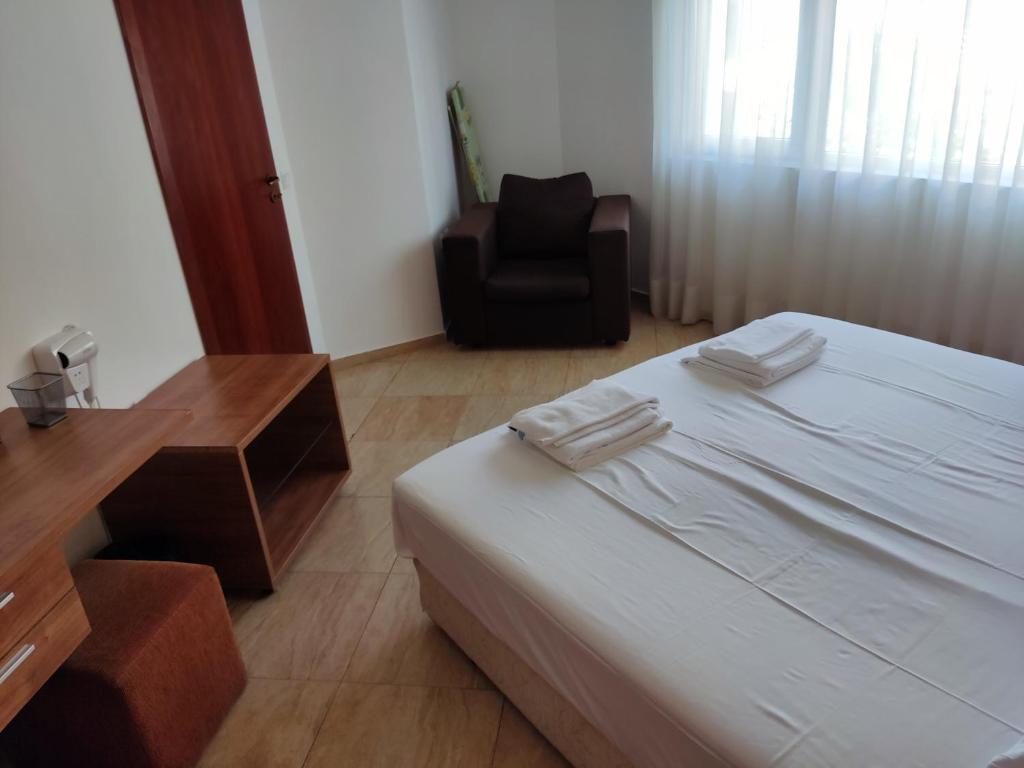 a bedroom with a bed and a desk and a chair at Charis Cozy Family apart at Sun Village Complex close to the Beach in Sunny Beach