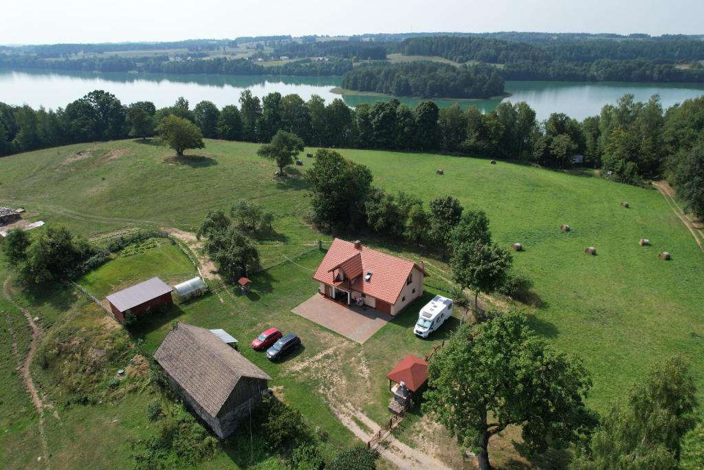 an aerial view of a farm with a house and animals at Zacisze nad Rospudą in Filipów