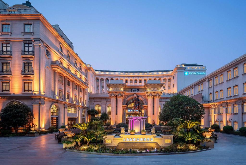 a large building with a fountain in front of it at Wyndham Shanghai Hongqiao in Shanghai