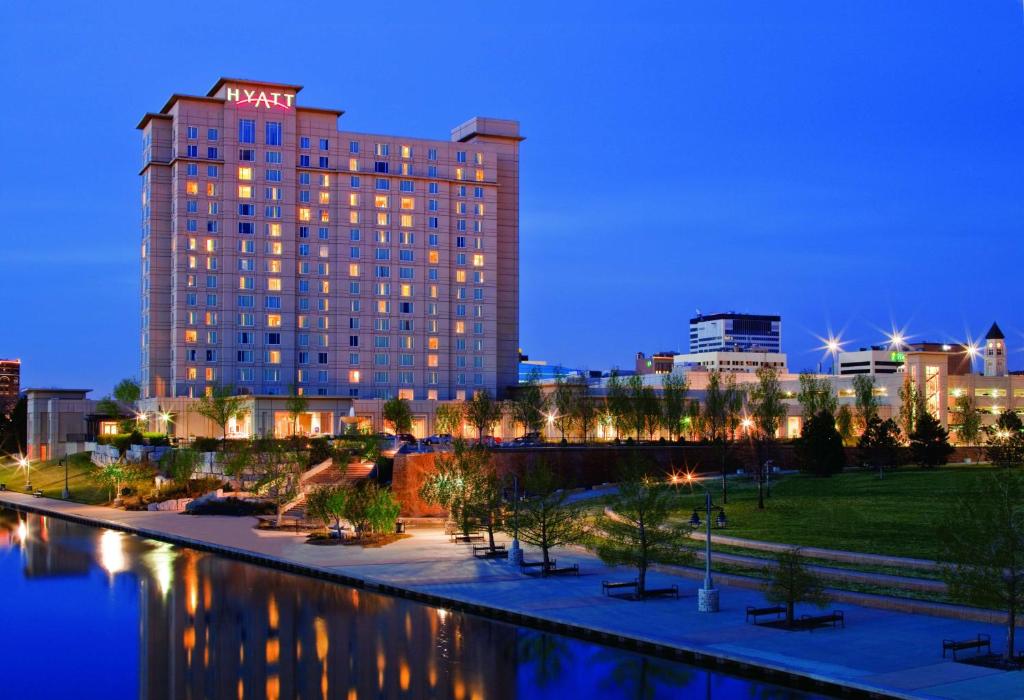 a hotel with a view of a city at night at Hyatt Regency Wichita in Wichita