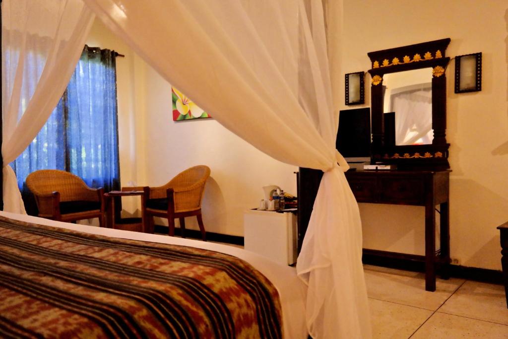TV a/nebo společenská místnost v ubytování Puri Cendana Resort Bali
