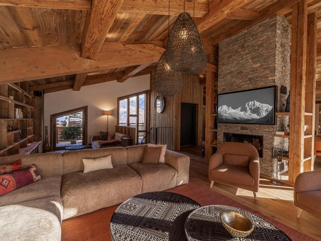 a living room with a couch and a fireplace at Chalet Courchevel, 6 pièces, 10 personnes - FR-1-568-33 in Courchevel