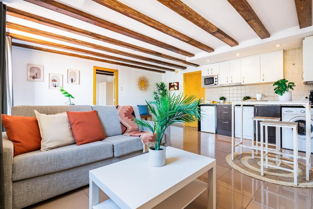 a living room with a couch and a table at Lodging Apartments Liceu G1 in Barcelona