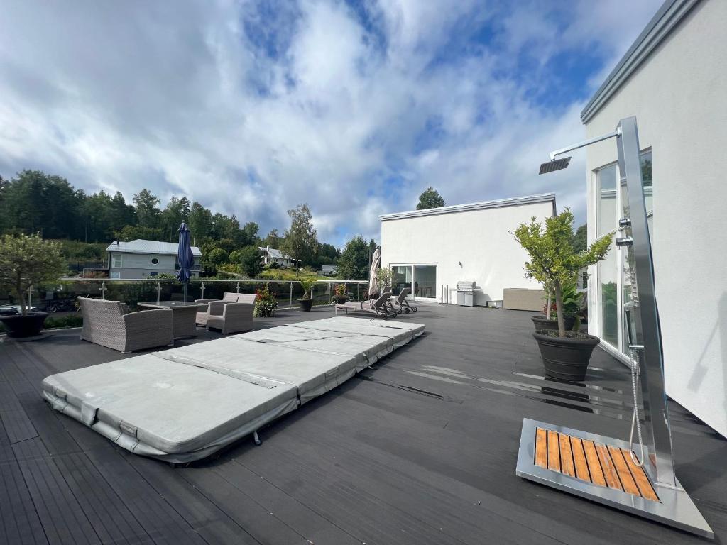 a mattress on the deck of a building at Luxory Vättern Lake Villa in Motala