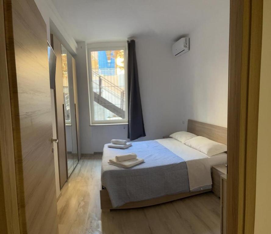 a small bedroom with a bed and a window at Villa Milano Apt. n. 3 in Milan