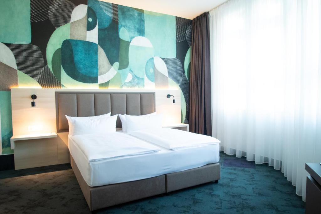 Postel nebo postele na pokoji v ubytování Taste Hotel Kulmbach