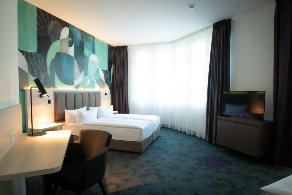 Postel nebo postele na pokoji v ubytování Taste Hotel Kulmbach