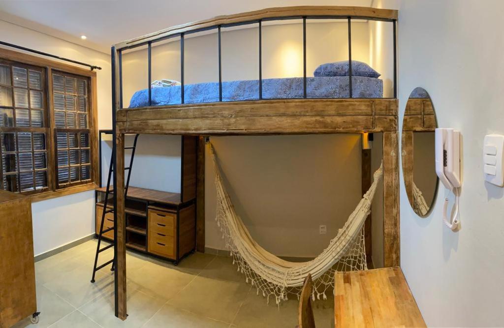 a loft bed with a hammock in a room at Hostel 364 Santos Dorm Privativo com Alexa in Santos