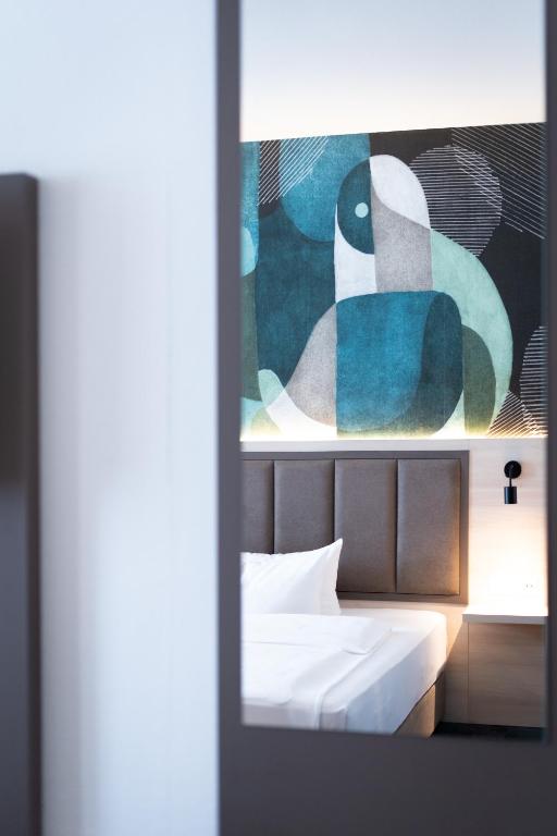 Postel nebo postele na pokoji v ubytování Taste Hotel Kulmbach