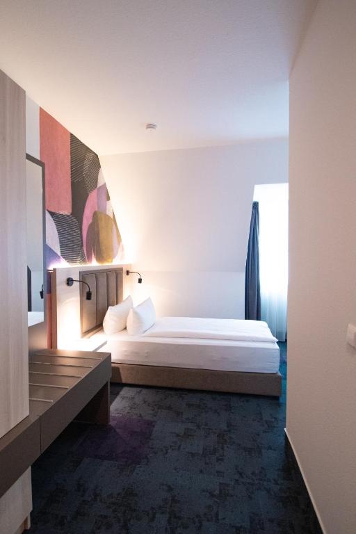 Postel nebo postele na pokoji v ubytování Taste Hotel Kulmbach