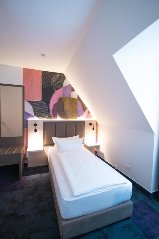 Postel nebo postele na pokoji v ubytování Taste Hotel Kulmbach