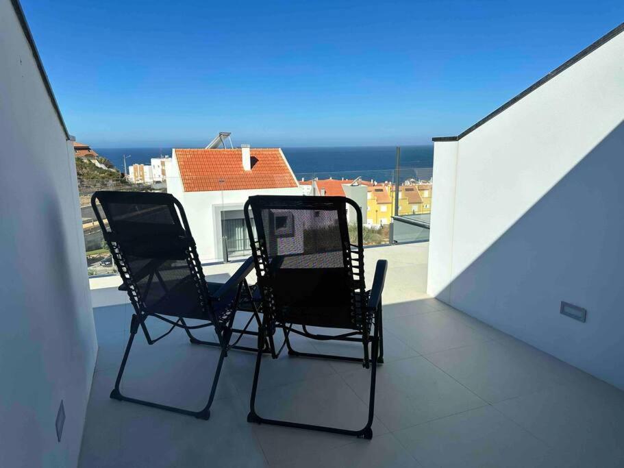 two chairs on a balcony with a view of the ocean at Beach, Ocean view & Bright House Ericeira in Ericeira