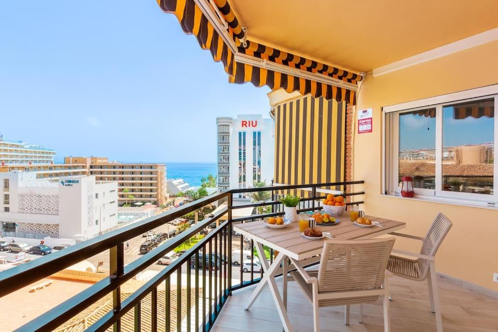 a balcony with a table and chairs and a view of the city at Santa Amalia 39 By IVI Real Estate in Torremolinos