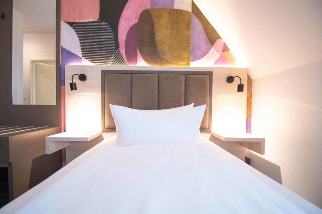 Postel nebo postele na pokoji v ubytování Taste Hotel Kulmbach