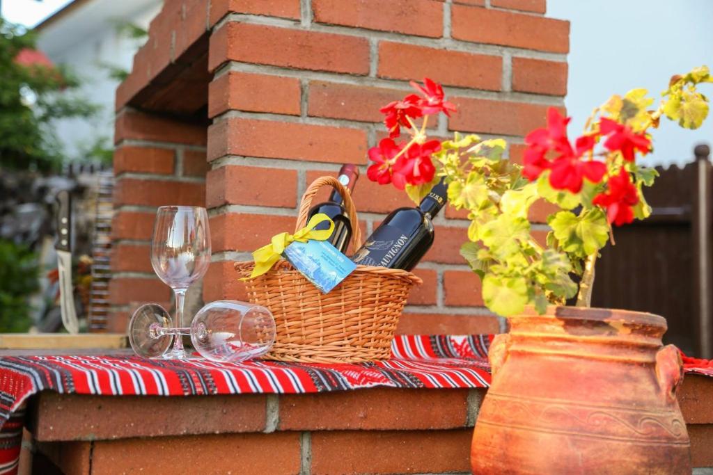 - une table de pique-nique avec un panier, des verres à vin et un vase dans l&#39;établissement Transylvanian Villa, à Predeal